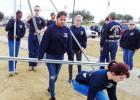 Cadets in the CCHS JROTC Bulldog Battalion carry poles and place them in sections for volunteers to fill with wreaths. More than 6,400 wreaths were retrieved last year by hundreds of volunteers.