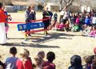 CCLP/DAVID J HARDIN - Fairview/Miss Jewell Students watch as Principal Leah Miller cuts the ribbon opening the new “Buddy Bench” on the campus Friday afternoon