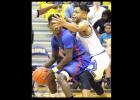 CCLP/TJ MAXWELL - Cove junior Dahmir Pearson defends against Midway senior Joe Ward in the first half of the Bulldawgs’ 53-50 win over the Panthers on Friday.