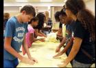 CCLP/PAMELA GRANT - Teenagers play with their own bits of dough at the dough show put on by Domino’s at the library. The dough show was the library’s reward to the teens at the end of the Summer Reading Program.