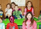 CCLP/KATHLEEN STARLING Reverend Paulette Magnuson with the smallest of her flock celebrate Shrove Tuesday with beads, masks and pancakes