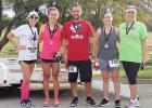 CCLP/PAMELA GRANT - Julie Moser and Jen Reynolds award medals to the 1st, 2nd, and 3rd place winners of the Pink Warrior Angels’ 2nd Annual Pink Warrior Dash 5k run/walk. Alex Wilson came in 1st, Christian Riedenaur came in 2nd, and Chellie Cannon came in 3rd.