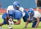 CCLP/DAVID MORRIS - Cove senior receiver Kendall Small dives into the end zone past a pair of defenders during the Bulldawgs’ annual Soap, Towel and Shampoo scrimmage Saturday at Bulldawg Stadium.