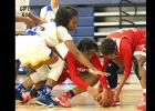Courtesy photo - Cove’s Oni Boodoo, left, fights for a loose ball during the Lady Dawgs 66-55 win over Crosby as part of the 2016 Aggieland Invitational Tournament. The Lady Dawgs finished fourth out of 30 teams in the field with a 3-2 tournament record.