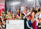 CCLP/BRITTANY FHOLER - The Rabbit Fest Royalty and the newly crowned Krist Kindl Royalty pose with a check with the amount raised for Mitochondrial Disease awareness at the 2nd annual Miss Krist Kindl Charity Pageant held in Bearables in downtown Copperas Cove Saturday morning.