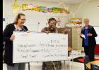 CCLP/BRITTANY FHOLER - Andrea Cardon and Crystal Buckram get sprayed with silly string as they hold the check for their $3,130 grant at J.L. Williams/Lovett Ledger Elementary Thursday morning.