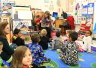 Courtesy Photo CCISD - Benefits Specialist Shirley Bennett reads to students at Mae Stevens Early Learning Academy in conjunction with International Literacy Day. The school used a round robin strategy as students changed classes listening to a variety of guests read aloud books related to the Christmas holiday.