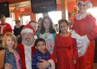 CCLP/LYNETTE SOWELL - Jessica Centunzi-Sanchez, as Mrs. Claus, and Phillip Imergoot, as Santa Claus, pose with kids at Saturday morning’s pancake breakfast fundraiser for Relay For Life Lampasas-Copperas Cove at Applebees. Sanchez is the event team leader for Lampasas, and Imergoot is part of the Copperas Cove event team.