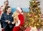 CCLP/DAVID MORRIS - Alyssa Morris visits with Santa after making a stuffed giraffe at Bearables Sunday.