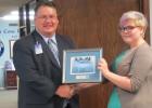 CCLP/BRITTANY FHOLER - CCISD Superintendent Dr. Joe Burns presents Elissa Dean, a CCHS Senior who won 1st place in the CCISD Holiday Card contest, with her framed card.