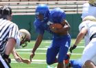 Copperas Cove junior runningback Antonio Lealiiee splits a pair of Abilene defenders on his way to the end zone during the controlled portion of their scrimmage Friday at Shotwell Stadium in Abilene.