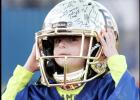 File Photos - Hedger puts on a Baylor Bear helmet signed by the entire football team.