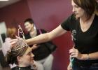 CCLP/DAVID MORRIS Tonia Lee of A Blissful Escape adjusts the crown of Ms. Rabbit Fest Trisha Stutz after styling her hair during a recent visit.