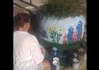 CCLP/LYNETTE SOWELL - Catherine Blashack prepares to add more details to the wildflowers she painted on the concrete planter on the corner of Avenue E and South 2nd St. in downtown Copperas Cove.