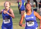 Copperas Cove sophomore Amber Boyd, right, races past Temple’s Ashley Raynard on her way to a second place finish during the Temple Invitational cross country meet Friday at Temple Lions Park.