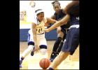 CCLP/TJ MAXWELL - Cove senior Keturah Taylor drives the lane against Shoemaker junior Mikayla Koester on Tuesday.