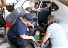 CCLP/PAMELA GRANT -  Firefighter Kris Hurst shows Shirley Anderson how to properly strap her grandson, AJ Zavala, into his new car seat.