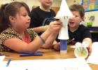 Clements/Parsons Elementary 3rd graders Emily Cook, Lukas Trevino and Michael Griffin discuss how they should build their plant and animal models for their assigned habitat and how it should look as part of their STEMscopes science project.