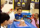 CCISD/Brandy Petty - Three- and 4-year-olds Ezekiel Garcia, Lashia Jones and Asher Diaz scream with excitement as they watch a volcano they built erupt in their classroom. The project met several pre-K learning guidelines in science as well as life skills.
