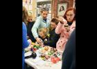 CCLP/LYNETTE SOWELL - Families lined up to decorate ornaments on Monday at Frames & Things at the Crafting With Santa event.