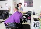 CCLP/PAMELA GRANT<br>Elizabeth Littlejohn trims Kevin Esfahuni’s hair. Littlejohn is the owner of Paisley Barber Shop & Salon in Cove Terrace Shopping Center.