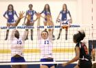 CCLP/TJ MAXWELL -- Copperas Cove juniors Chyanne Chapman (13) and Brianna Acker (17) combine for a block on the shot of Harker Heights senior Kennedi Foster during their 3-1 win on Tuesday. 