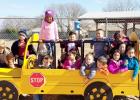 COURTESY PHOTO - Mae Stevens Early Learning Academy students enjoy playing like they driving the car on the school’s new playground. Things like shifting gears on a car or scaling a climbing wall develop gross motor skills and require deliberate movement.