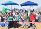COURTESY PHOTO - Mae Stevens Early Learning Academy principal Mary Derrick cuts the ribbon on the school’s new playground surrounded by school staff and CCISD superintendent Joe Burns and deputy superintendent Rick Kirkpatrick.