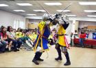 CCLP/LYNETTE SOWELL - Members of the Society for Creative Anachronism perform an armored combat demonstration at Wednesday morning’s summer reading program kickoff.