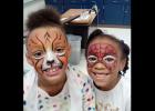 CCISD/COURTESY PHOTO - Clements/Parsons Elementary Malaiyuh Floyd Walters and Assiya Turner show off their freshly painted faces with Walters as a lion and Turner as Spiderman. The two girls each earned 100 Bee Bucks, a school currency for good behavior,