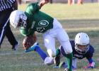 Warriors’ running back Asher Fugitt is tripped from behind by Cowboys’ Bobby Joe Millican during their playoff game Saturday at the Avenue E Sports Complex. The Warriors advanced to Saturday’s semi-finals against the Horned Frogs.