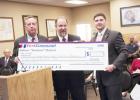 Copperas Cove Librarian Kevin Marsh, center, accepts a check for $500 from First Command Financial Planning in Killeen to be used for the purchase of new books.