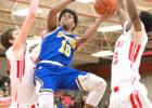 Cove junior Devante Robinson shoots between two Belton defenders during their 59-40 win. Cove is in a three-way tie for third place at 3-3.