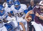 A host of Copperas Cove defenders, led by Phil Aumua (33), pursue Round Rock quarterback Colin Hinson during the Bulldawgs 26-0 loss to the Dragons Friday at Dr. R.L. Peters Jr. Field in Round Rock.