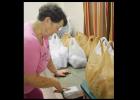 Nancy Cranfill checks the menu for the food bags at Free Lunch Saturday held at Five Hills Assembly of God.