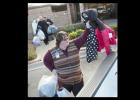 Copperas Cove Junior High Communities in School advisor Stacy Bradley loads a handful of jackets into her vehicle after collecting them from Holy Family Catholic Church.