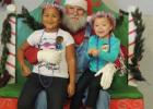 Santa poses for photos with children during the annual Christmas on the Farm celebration in Belton.