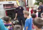 Ethan Westbrook shows the Jaws of Life to a group of young readers as they visit the library for Big Trucks day Tuesday.