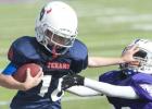 Tackle football players are shown during the 2013 CCYFL championship game. The tackle football program is facing cuts and may be eliminated.