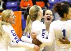 Members of the Lady Dawgs volleyball team celebrate their 3-1 (25-23, 22-25, 25-22, 28-26) win over the Rockwall Lady Jackets Tuesday night in Corsicana.