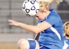Shelbie Letzer heads a midfield air ball in the bi-district loss to Longview in Corsicana during the 2012-13 season.
