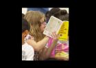 Alexi Dickson, 9, reads through her dictionary during an assembly at Williams Ledger Elementary School.