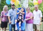 Mona Lopez enjoys her new play area from the Make-A-Wish Foundation. Left to Right: Cindy Daly, Gabriel Lopez, Mona, Mira Lopez, Bill Daly.