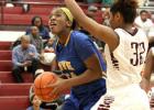 Cove sophomore Chyanne Chapman attempts a shot in front of Killeen sophomore Jacen Moore during their game Tuesday in Killeen. The Lady Roos won 54-44