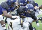 Former Copperas Cove quarterback/receiver Robbie Seybold, center, leads a host of Crusader defenders on a stop of Texas Lutheran’s Demetrius Brock during their contest that spanned two days. The Cru won 27-20.