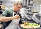 Yaghi’s New York Pizzeria owner, Rod LaBrie prepares a fresh half Margherita and Spinach Roasted Garlic stone baked pizza for ustomers
Tuesday.