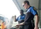 Copperas Cove senior Shawn Noorlun mans the grill as Police Explorers Tyrell Washington and Jason Stanley prepare hamburgers during the cookout funds raiser Saturday at Just Glocks.