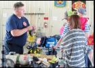 CCLP/J.S. FREDERICK - Firefighter/Paramedic John Burgan explains the equipment to citizens as they take a tour of Central Fire Station Saturday morning. Partnering with Benny Boyd of Lampasas the department raised more than $4,800 during the open house.