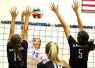 Copperas Cove senior Savannah Cook hits into the Vandegrift defense as Jacqueline Ribeiro (14) and Bella Benoit defend during their game Tuesday at Bulldawg Gymnasium. Cove won 21-25, 25-12, 25-16, 25-22 to move to 2-0 on the season.