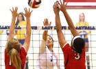 Cove senior captain Mikayla Blount hits for a kill between two Belton defenders during their sweep of the Lady Tigers in last Tuesday’s season finale. The Lady Dawgs (35-10, 10-2) will face the Rockwall Lady Yellowjackets (25-14, 12-2) at 7 p.m. tonight at Corsicana High School in the Bidistrict round of the UIL 2014 State Volleyball Championships.